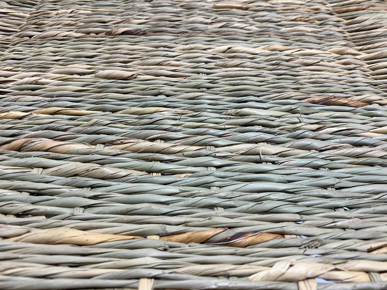 Close-up detail of handwoven natural fibre showing the tight, even weave pattern of African artisan craftsmanship