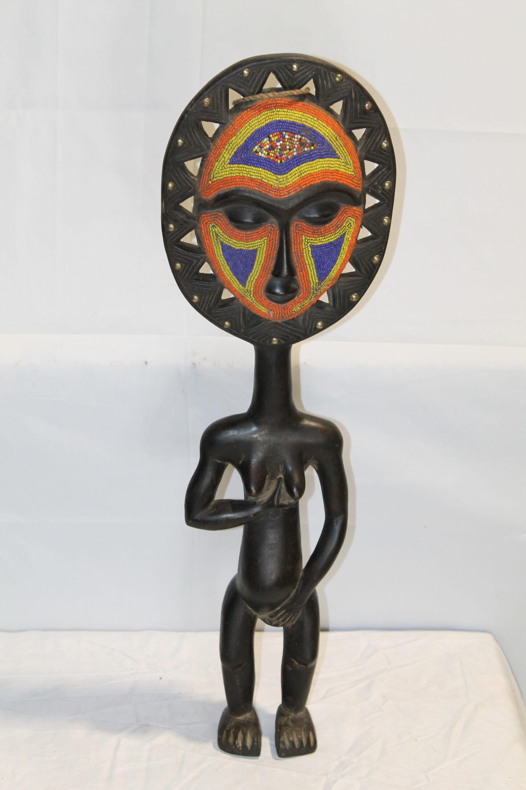 Handcrafted African beaded statue with colourful beadwork face in red, blue, and yellow on a carved dark wood figure
